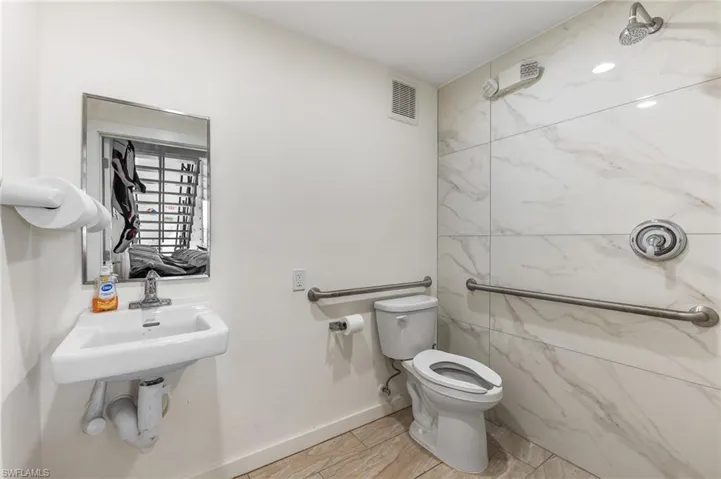 Bathroom with toilet and baseboards