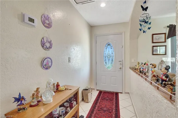 Entryway with tile flooring and a textured ceiling