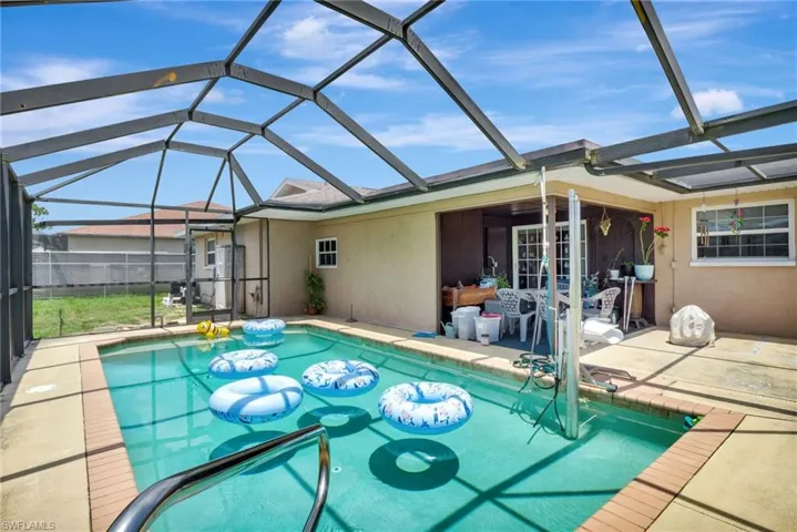View of pool with a patio area and a lanai