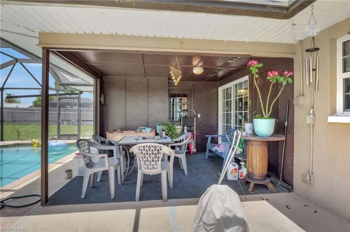 View of terrace featuring glass enclosure and a fenced in pool