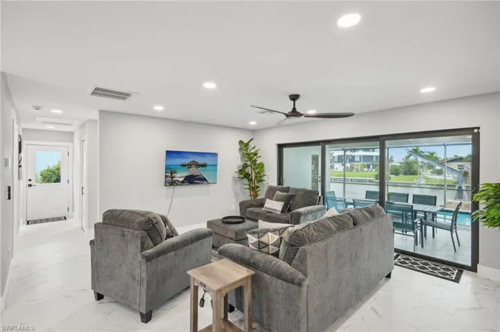 Living room featuring light marble finish floors, recessed lighting, and a ceiling fan