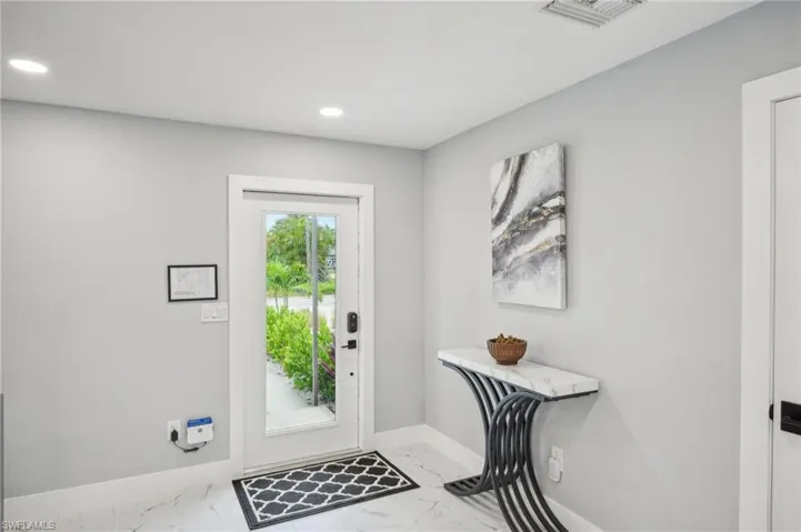 Entryway with marble finish flooring and recessed lighting
