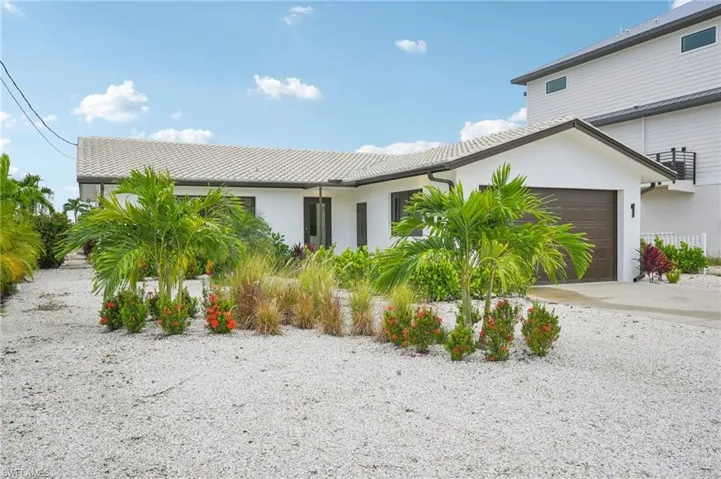 View of front of home featuring stucco siding and concrete driveway