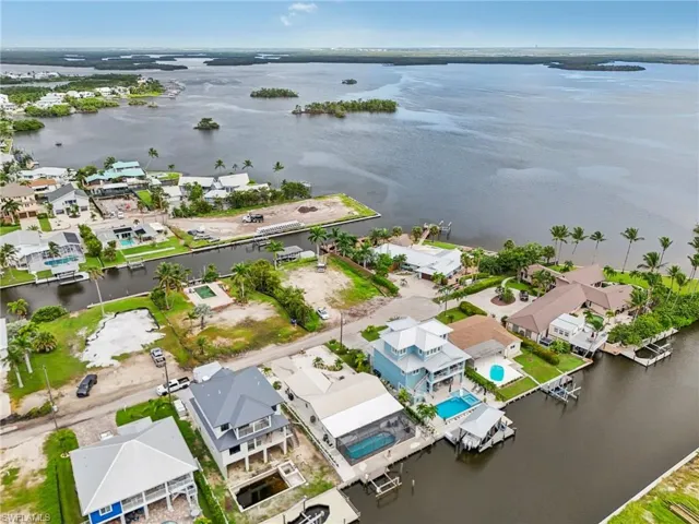 Aerial perspective of suburban area featuring a nearby body of water
