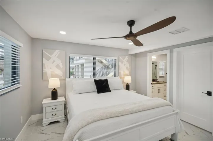 Bedroom featuring light marble finish flooring, a ceiling fan, recessed lighting, and multiple windows