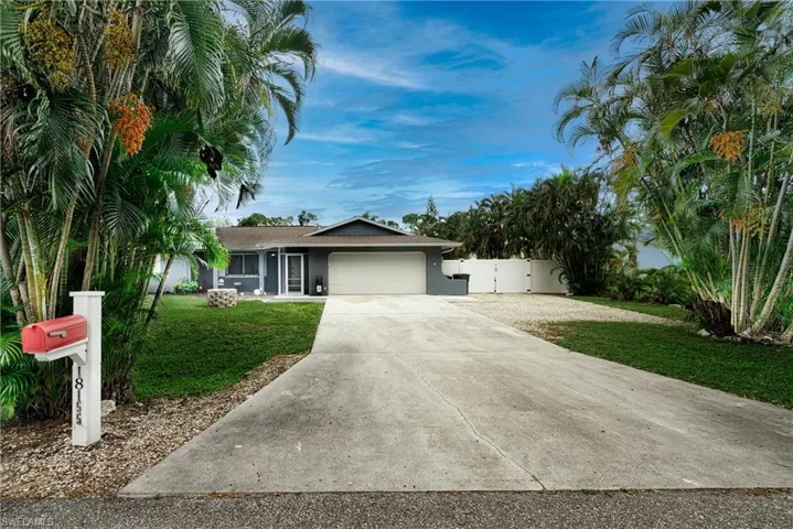 Ranch-style house featuring a garage and a front yard