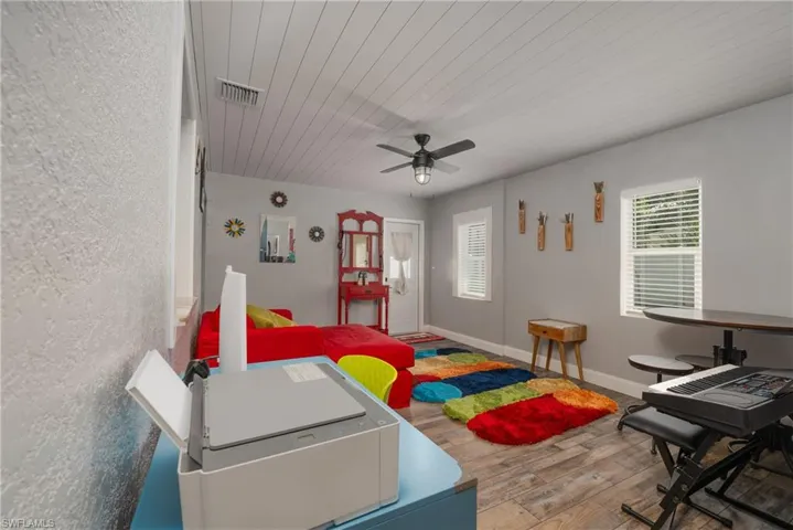 Game room with wood ceiling, ceiling fan, and hardwood / wood-style flooring