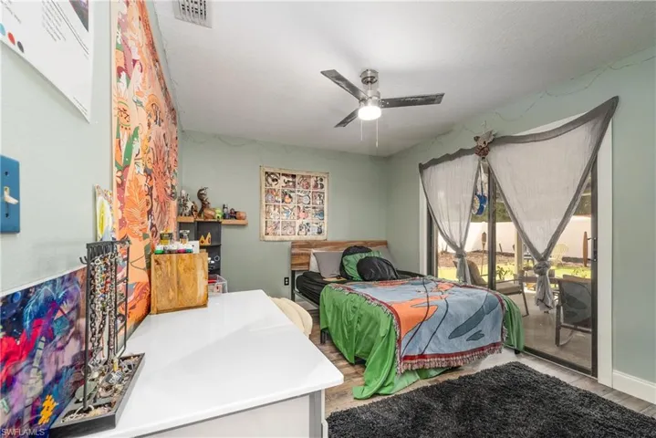 Bedroom featuring ceiling fan and access to exterior