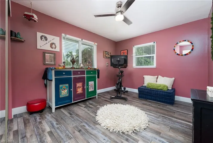 Sitting room with ceiling fan and hardwood / wood-style floors