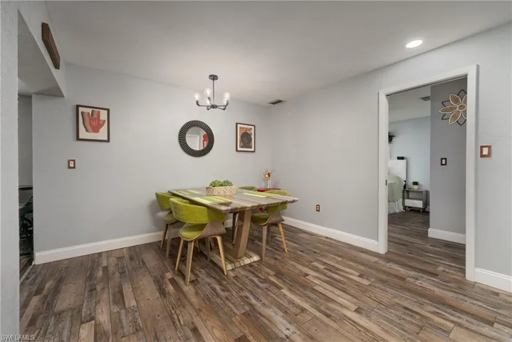Dining space featuring hardwood / wood-style floors and an inviting chandelier