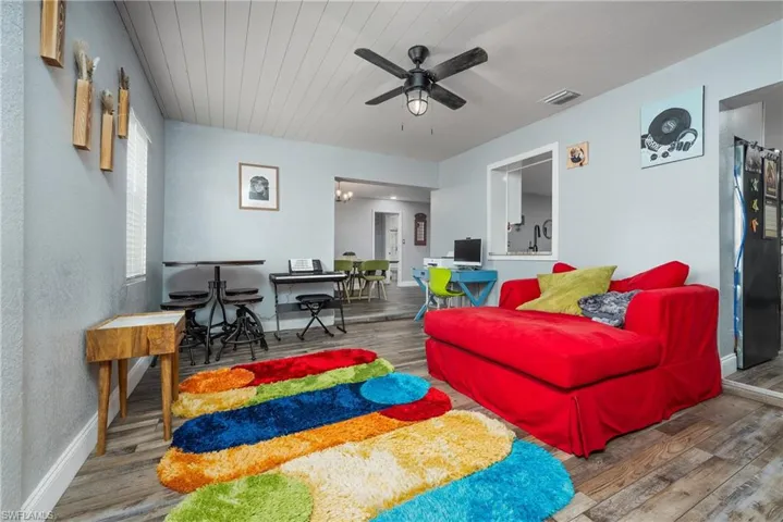Living room with ceiling fan and wood-type flooring