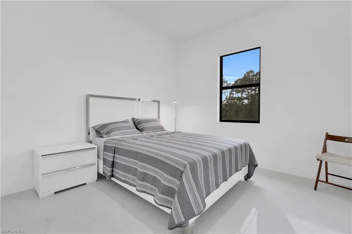 Bedroom featuring light marble finish flooring