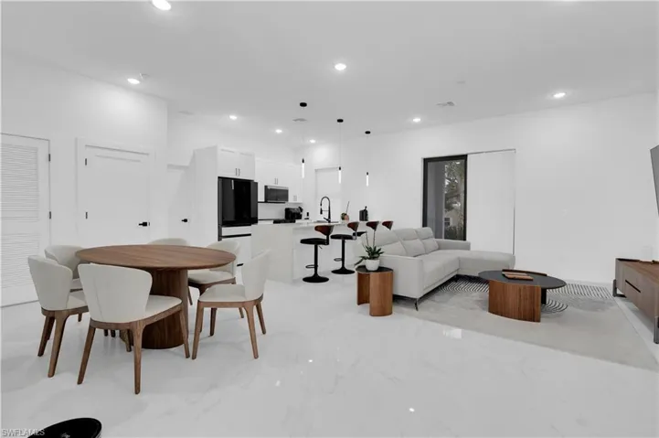 Living area featuring recessed lighting and light marble finish floors
