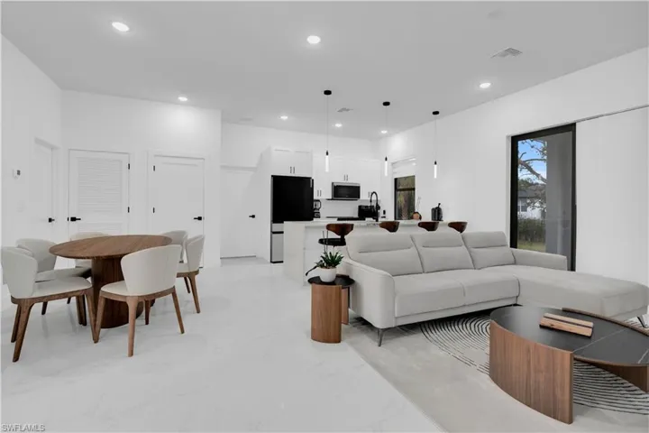 Living room featuring recessed lighting and light marble finish floors
