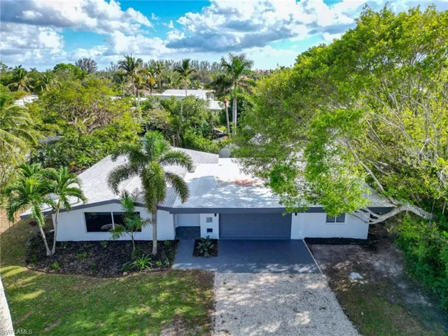 View from above of property with a tree filled landscape