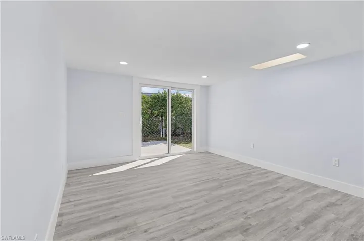 Spare room featuring wood finished floors and recessed lighting