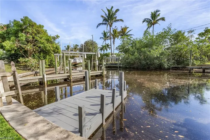 Dock area featuring a water view and boat lift