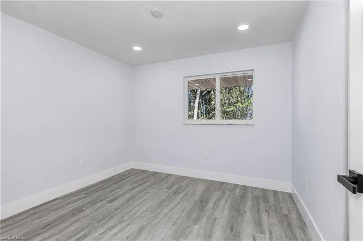 Empty room with wood finished floors and recessed lighting
