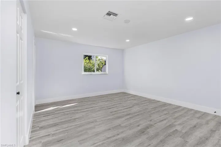 Unfurnished room with light wood finished floors and recessed lighting