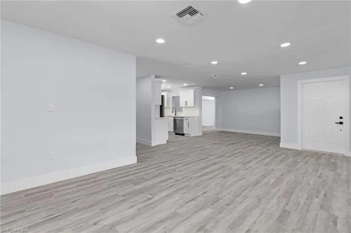 Unfurnished living room with light wood finished floors and recessed lighting