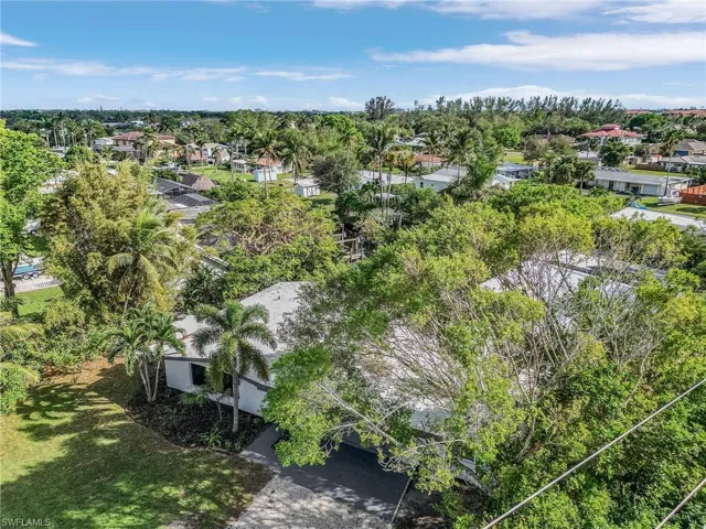 Aerial perspective of suburban area with a tree filled landscape