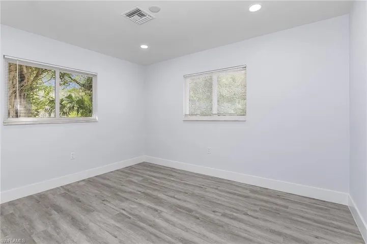 Unfurnished room featuring recessed lighting and wood finished floors