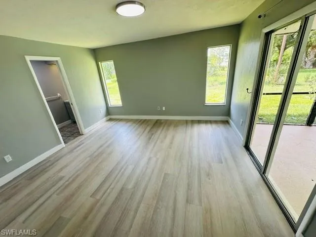 Spare room featuring light hardwood / wood-style flooring and a healthy amount of sunlight