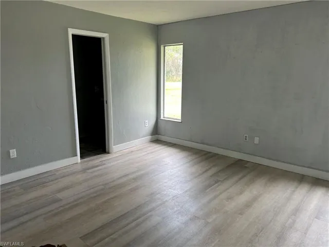 Unfurnished room with light hardwood / wood-style floors