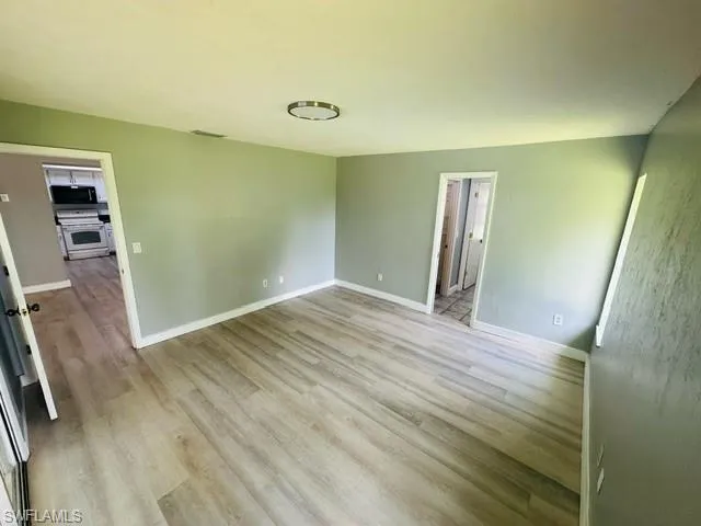 Spare room featuring light wood-type flooring