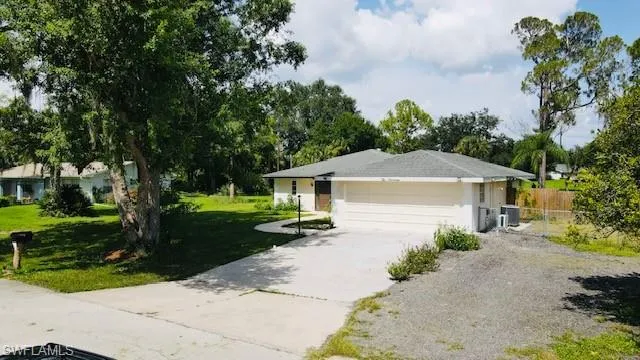Single story home with central AC, a garage, and a front yard