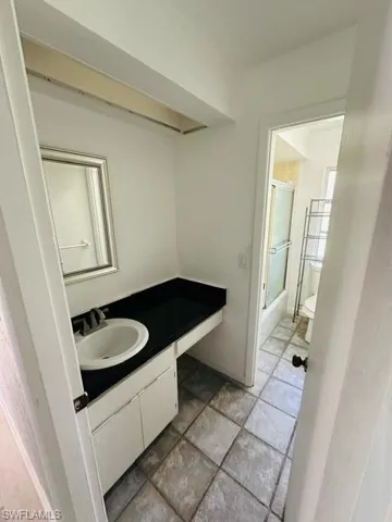Bathroom featuring tile patterned floors, vanity, and toilet