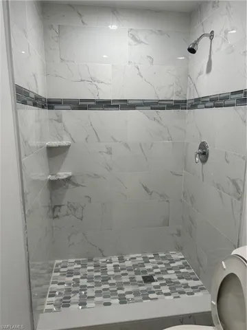Bathroom with toilet and a tile shower