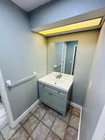 Bathroom with tile patterned flooring and vanity