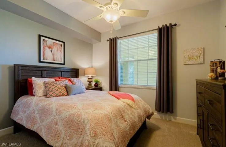 Bedroom featuring light colored carpet and ceiling fan