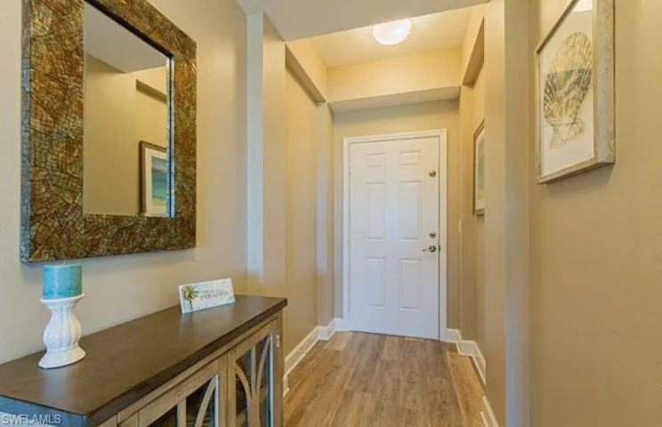 Doorway featuring wood finished floors and baseboards