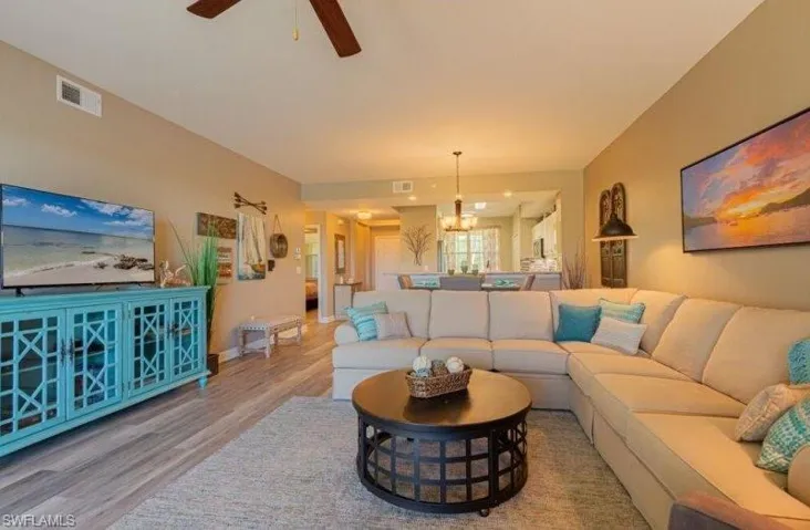 Living room with wood finished floors and a ceiling fan