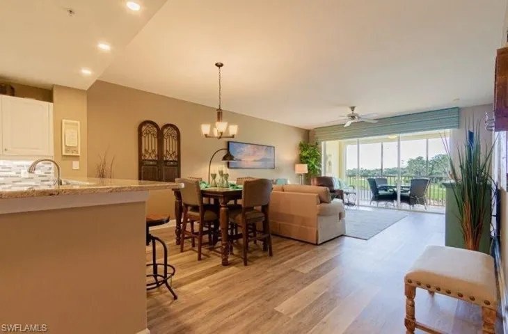 Dining room featuring ceiling fan, light wood finished floors, and suspended lighting