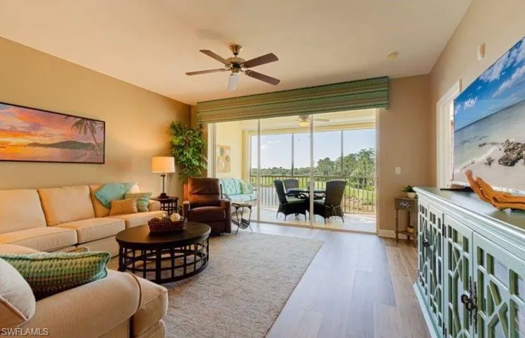Living room with a ceiling fan and wood finished floors