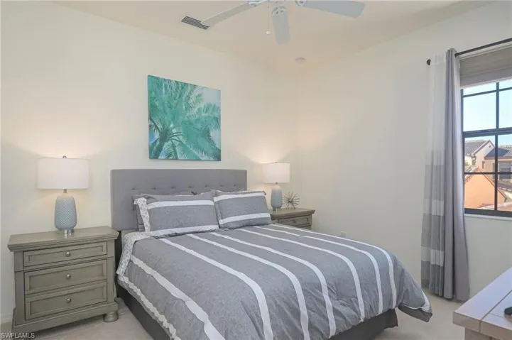 Carpeted bedroom with ceiling fan