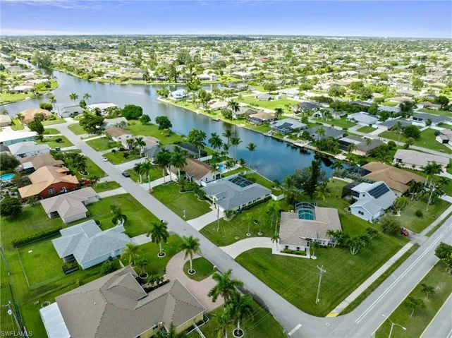 Birds eye view of property with a water view