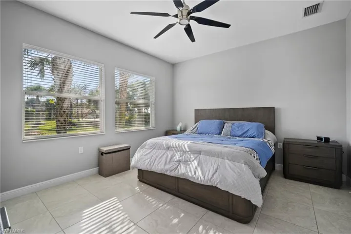 Tiled bedroom with ceiling fan