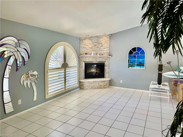 Tiled living room with a fireplace