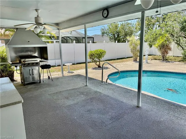 View of swimming pool with a fenced in pool, a patio, a grill, a ceiling fan, and a fenced backyard