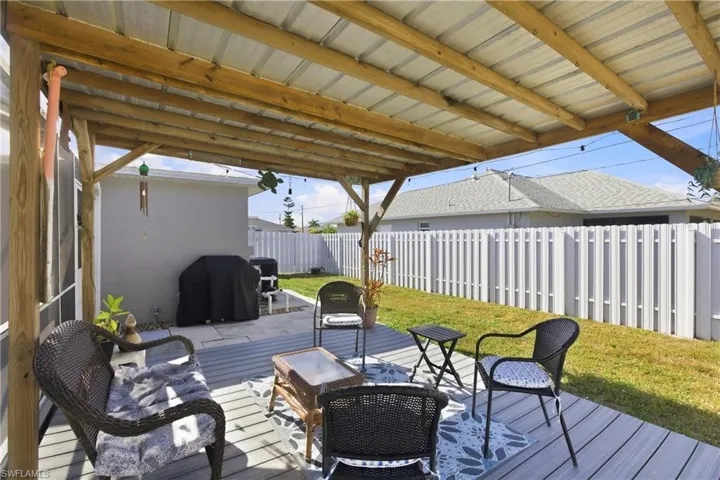 Deck with a fenced backyard and grilling area