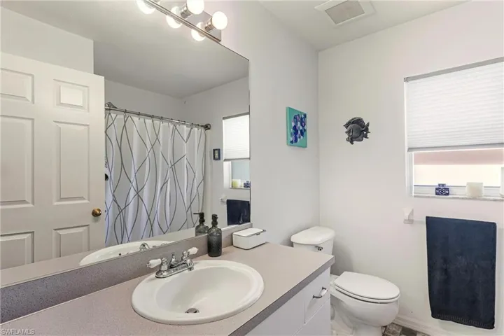 Bathroom with vanity and a shower with shower curtain
