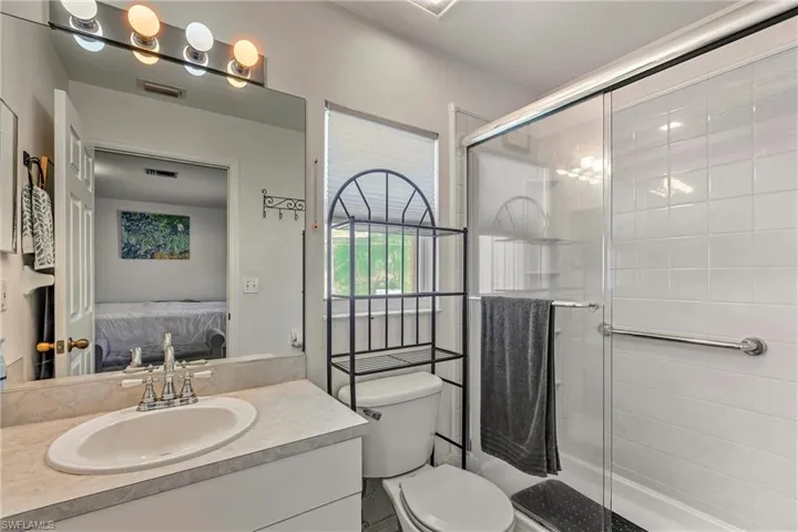 Bathroom featuring vanity, connected bathroom, and a stall shower