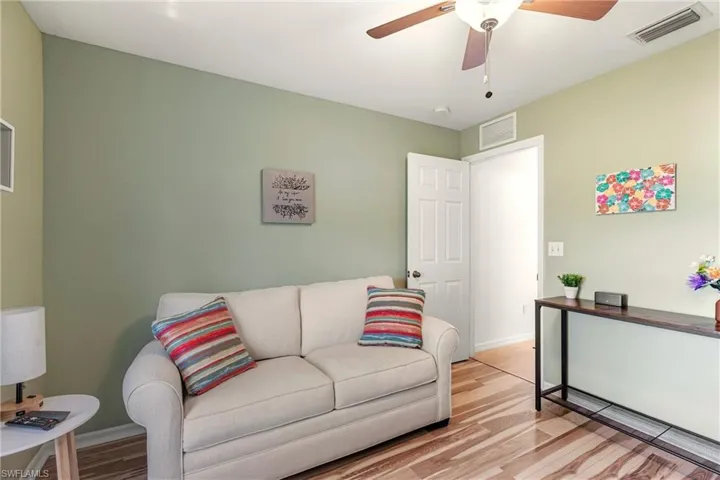 Living area featuring wood finished floors and ceiling fan