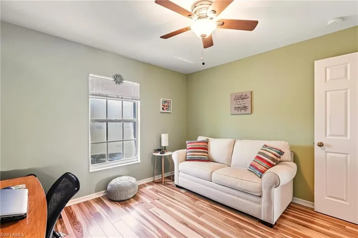 Living area featuring wood finished floors and a ceiling fan