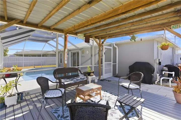 Deck featuring a lanai, a sunroom, a grill, and a patio