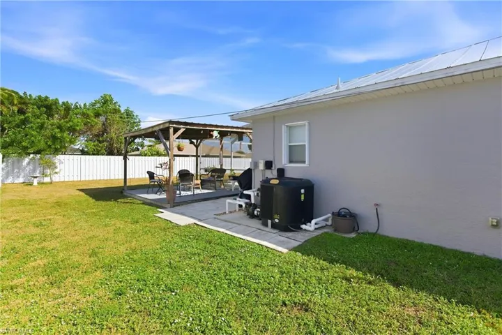 Fenced backyard featuring a gazebo and a patio area